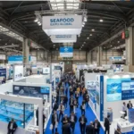 Wide-angle shot of Seafood Expo Global in Barcelona with aquaculture or technology booths visible. Why it works: Immediately signals this is a trade event Shows scale and professionalism Works well for Discover and News CTR