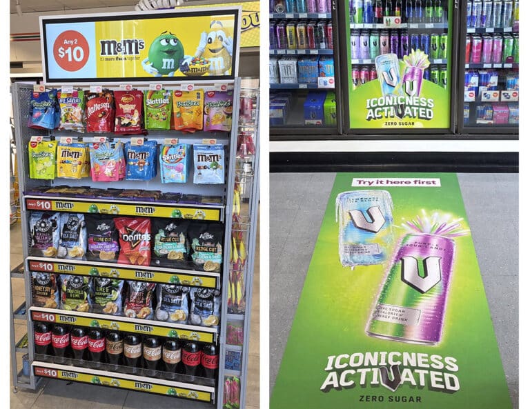 Confectionery display with an advertising screen alongside energy-drink advertising on a refrigerator and shop floor.