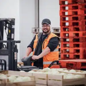 Priméale worker moving crates of melons