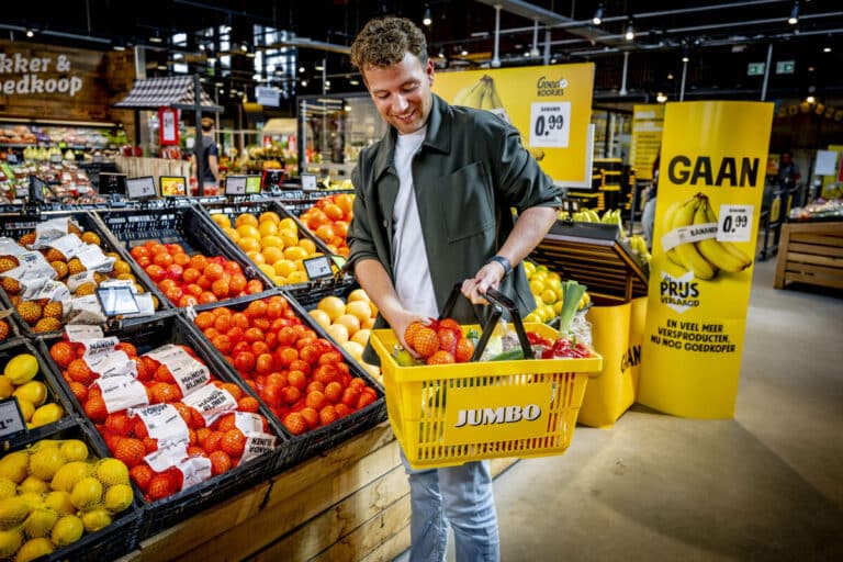 Shopper selecting fresh produce in a Jumbo supermarket