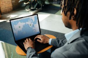 A person using a laptop displaying C.H. Robinson's Navisphere logistics map