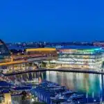 ICC Sydney and surrounding Darling Harbour buildings at dusk.