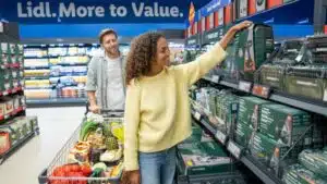 Two shoppers with a trolley inside a Lidl GB store