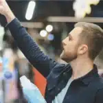 Shopper choosing a bottle of washing liquid