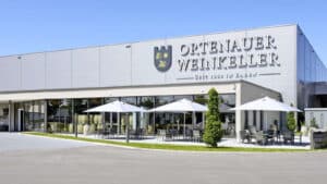 Ortenauer Weinkeller building with white umbrellas and outdoor seating