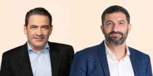 Two Paulig executives wearing jackets against a pale background.