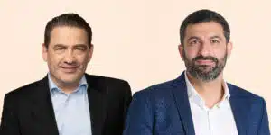 Two Paulig executives wearing jackets against a pale background.