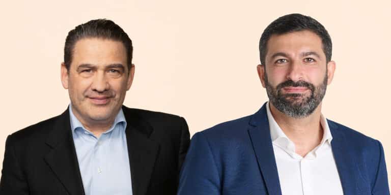 Two Paulig executives wearing jackets against a pale background.