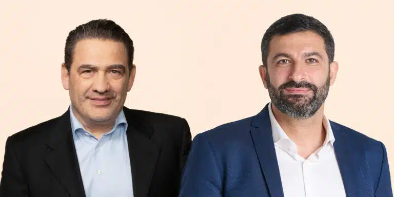 Two Paulig executives wearing jackets against a pale background.