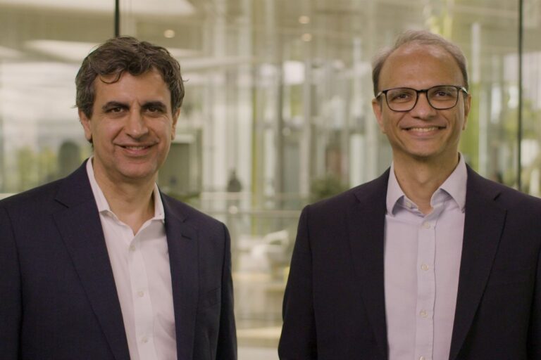 Fernando Fernandez and Srinivas Phatak standing together in dark jackets and light shirts