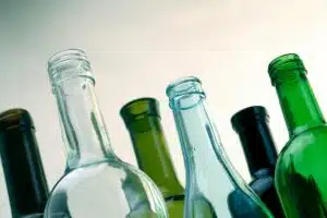 Clear and green glass bottles photographed from below